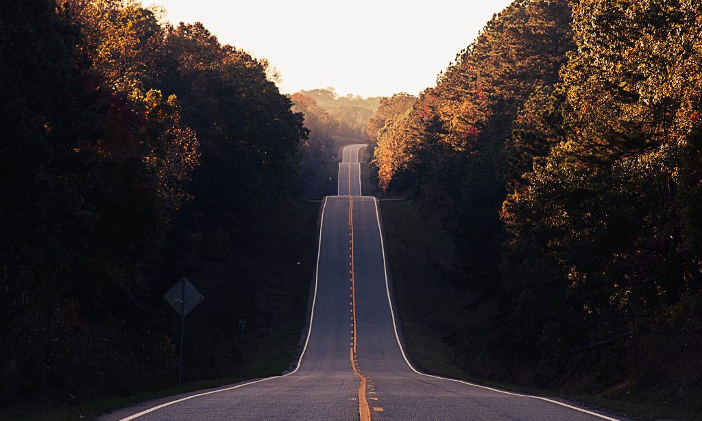 photo of stretching long road in a valley